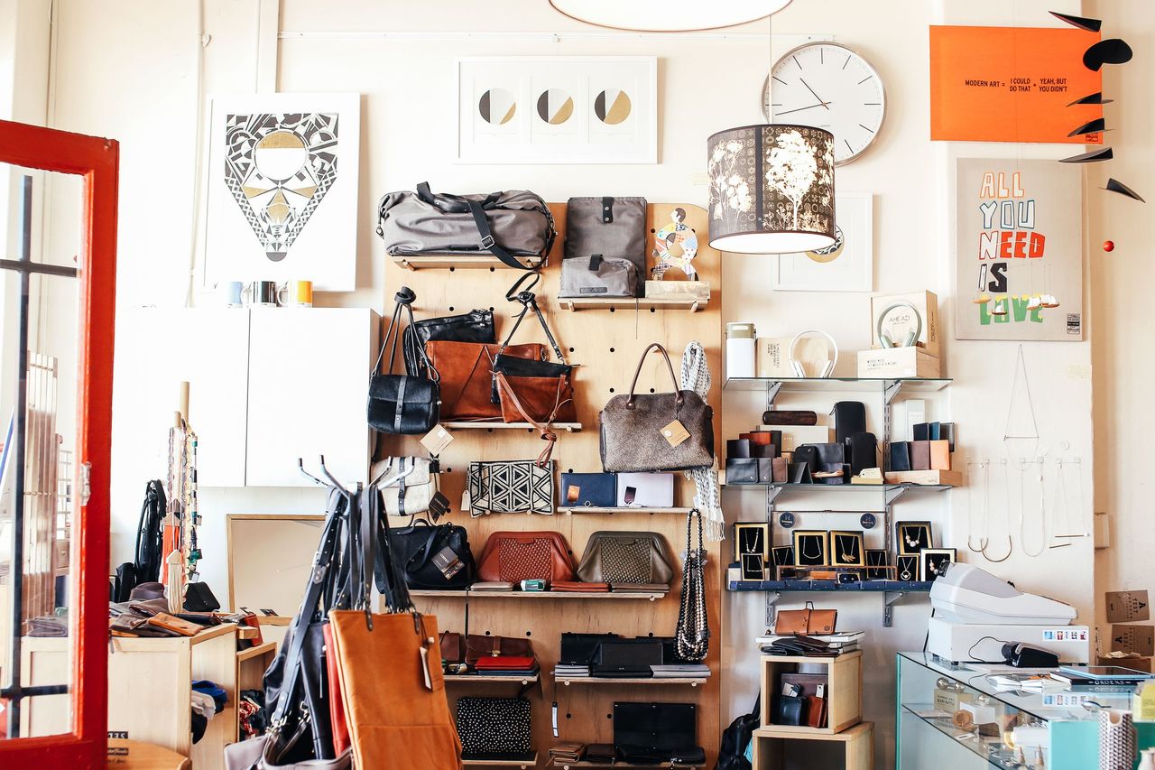 A bright boutique with leather bags and accessories displayed on wall shelves